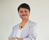 woman wearing blazer and smiling