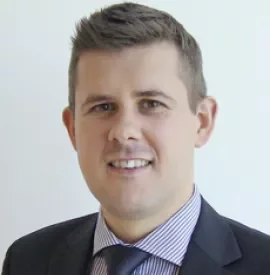 Person smiling in professional attire.