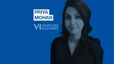 Person with short hair smiling on a blue background with text 'Priya Mohan Venture Highway'.