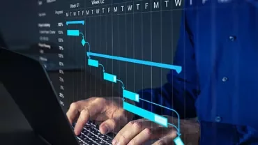 Person typing on a laptop with a Gantt chart overlay.