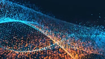Abstract image of blue and orange particles forming waves.