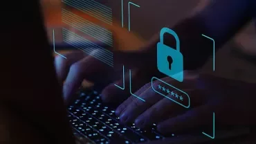 Hands typing on a laptop keyboard with digital lock security icon overlay.