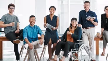 Group of colleagues smiling and sitting in an office