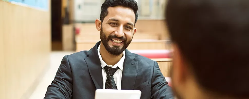 Person smiling and talking in a professional setting.