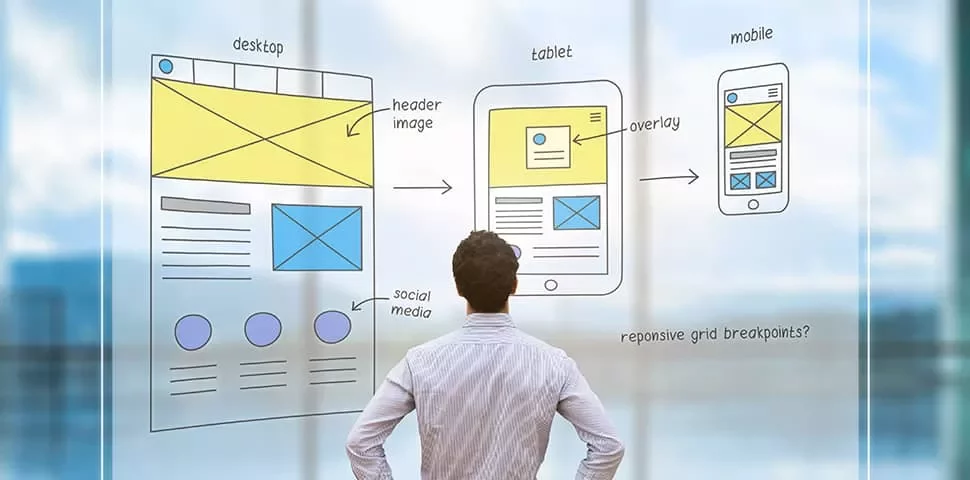Person looking at website wireframe sketches on glass.