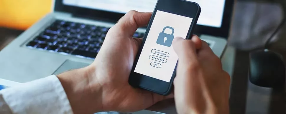 Person holding smartphone with lock screen for login.