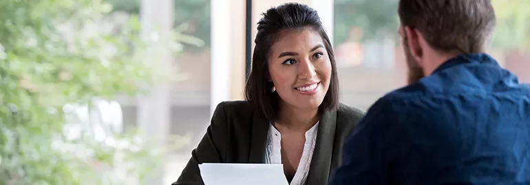 Two people having a conversation in an office setting.
